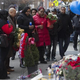 Emerald Garner (center left, holding blue candle), daughter of Eric Garner, visits a makeshift memorial near the site where two New York City police officers were slain.
Yahoo Screenshot